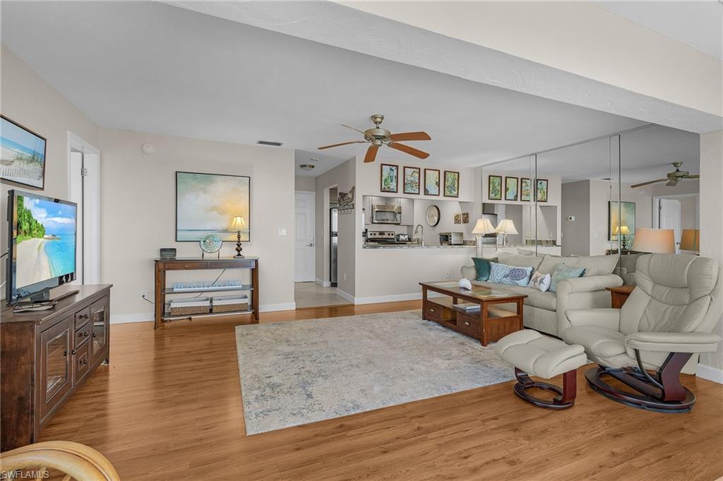 Living room featuring ceiling fan and light wood-type flooring