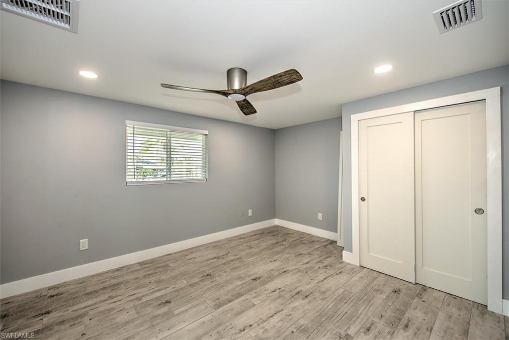 Unfurnished bedroom featuring a closet, ceiling fan, and light hardwood / wood-style floors