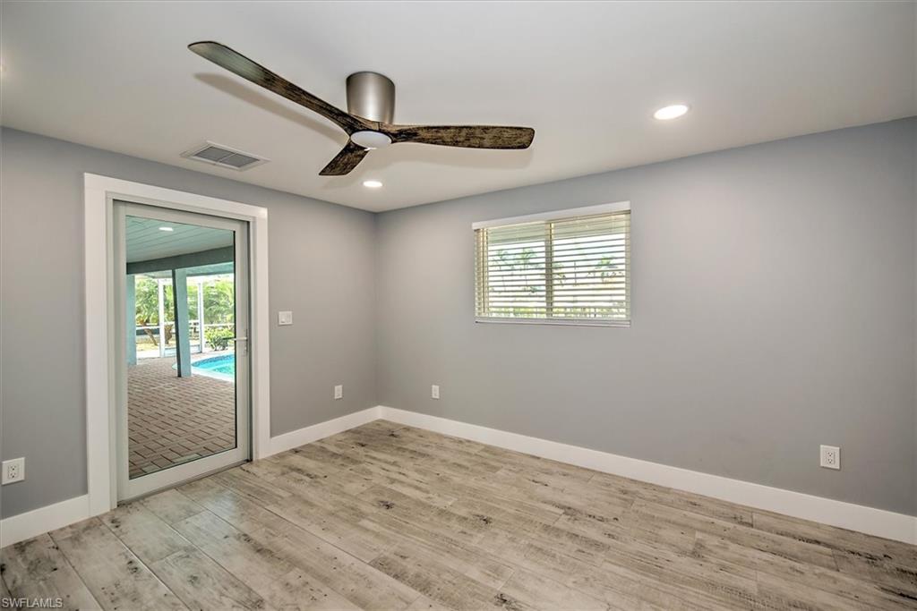 Unfurnished room with ceiling fan and light hardwood / wood-style flooring