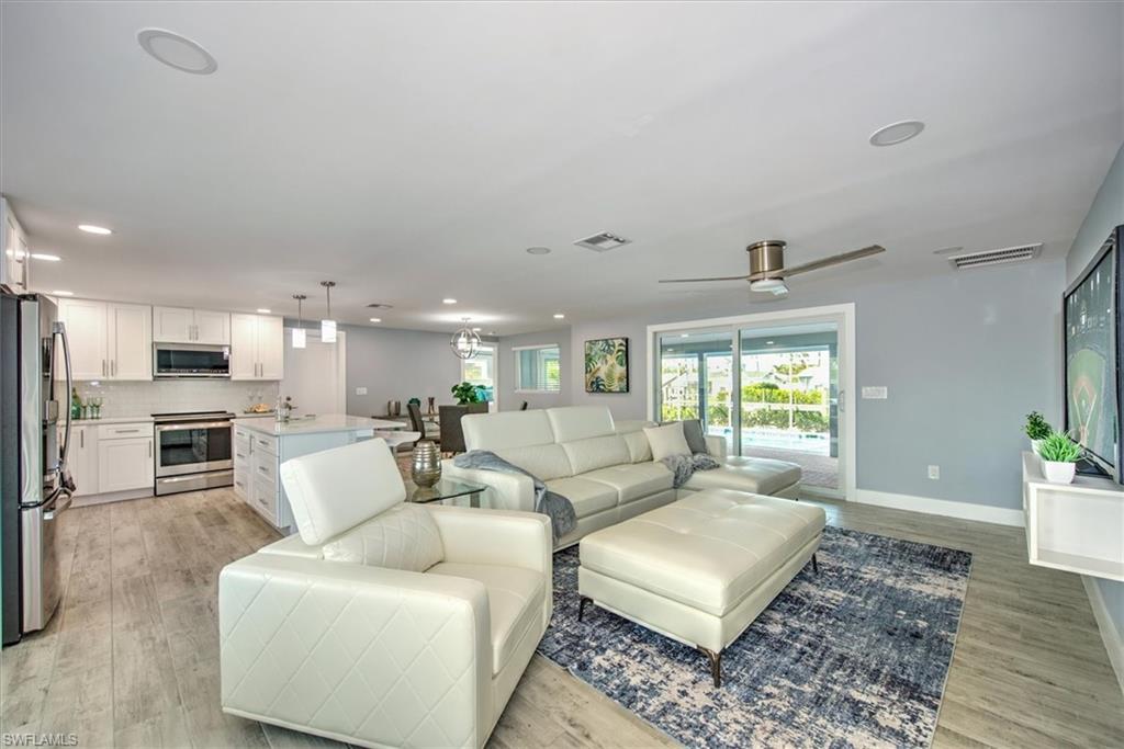 Living room featuring ceiling fan and light hardwood / wood-style flooring