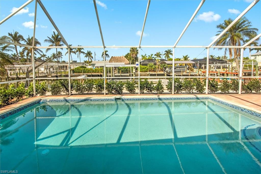 View of swimming pool with glass enclosure