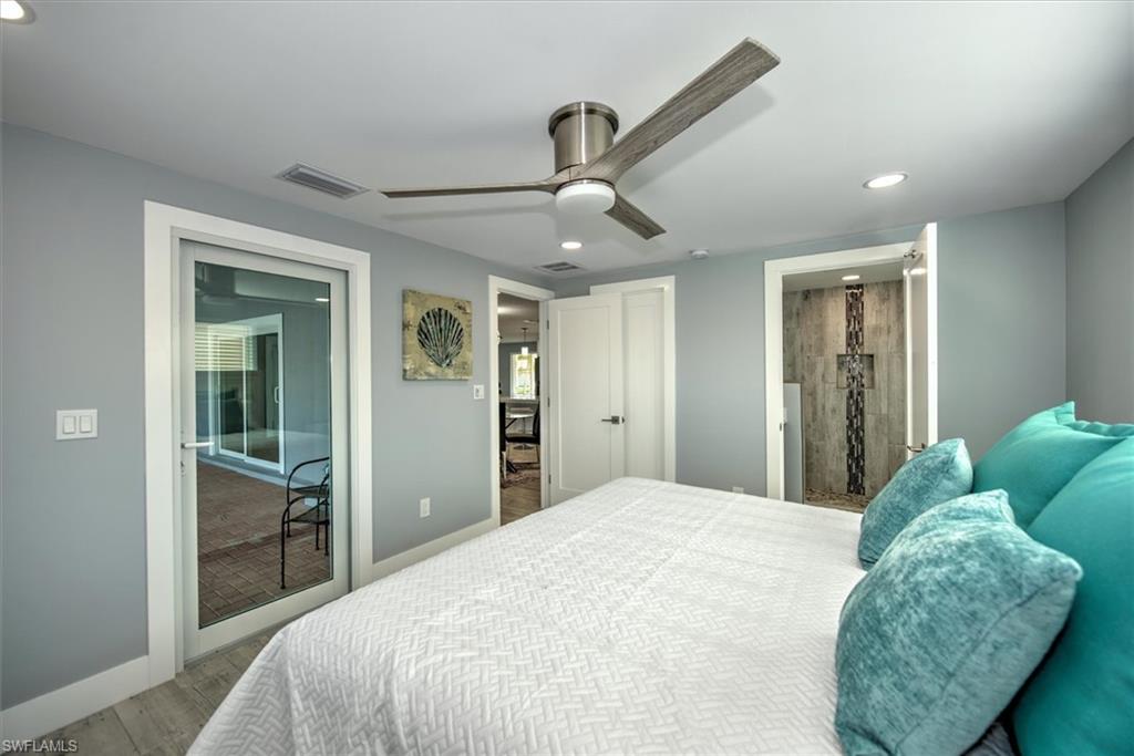 Bedroom with ceiling fan and light wood-type flooring