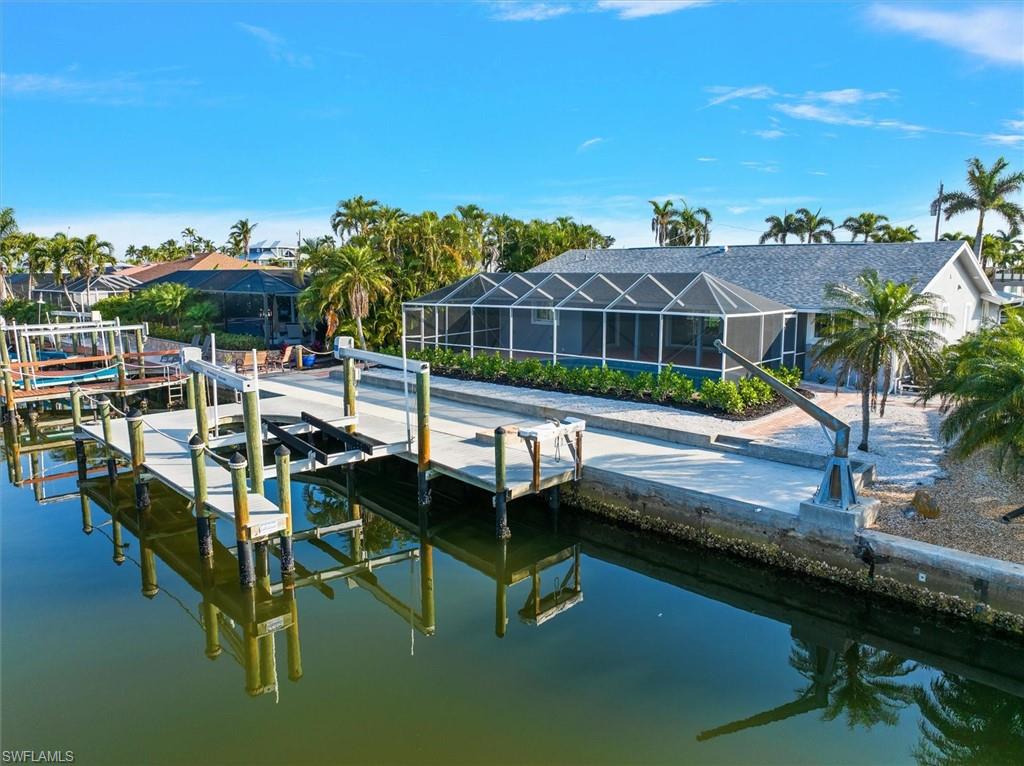 View of dock with glass enclosure and a water view