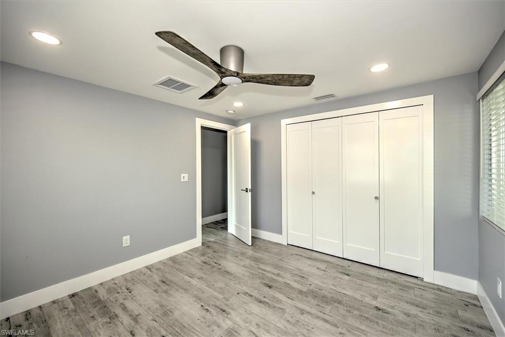 Unfurnished bedroom featuring a closet, ceiling fan, and light hardwood / wood-style floors