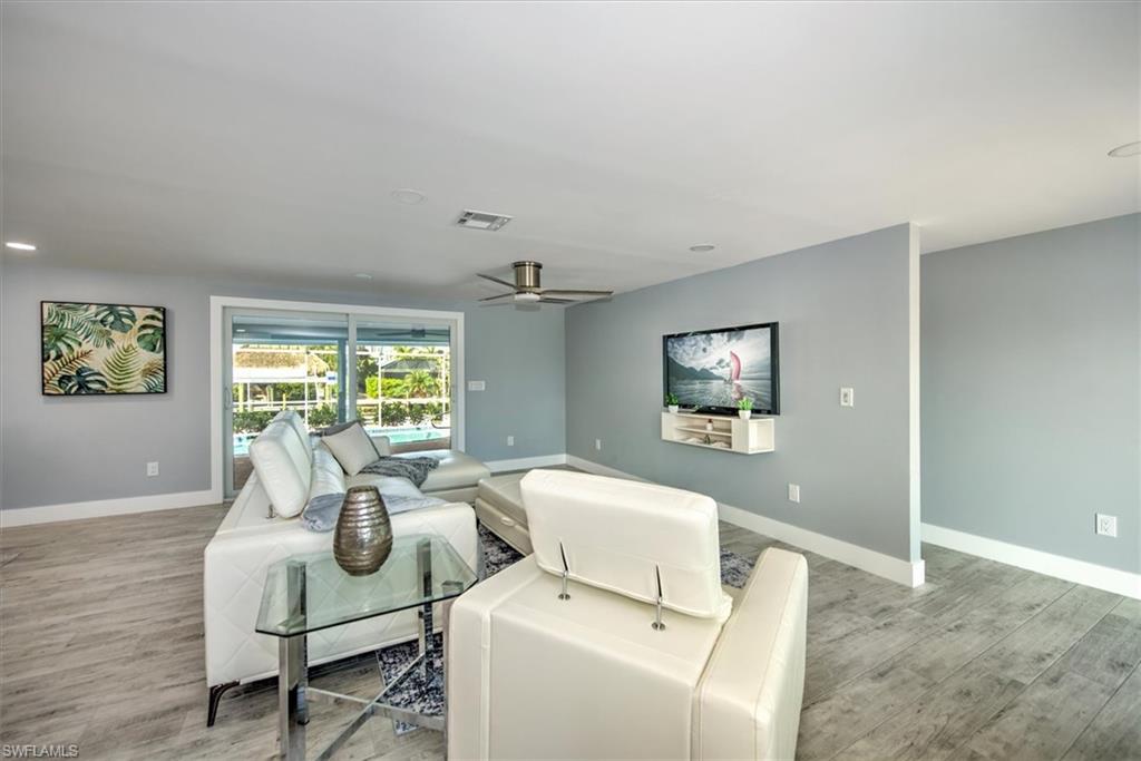Living room featuring ceiling fan and light hardwood / wood-style floors