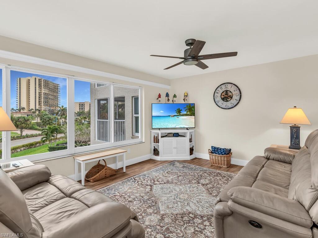 Living room featuring hardwood / wood-style flooring and ceiling fan