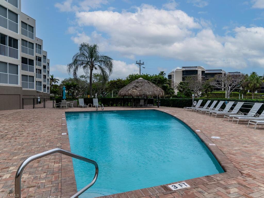 View of pool with a patio area and a gazebo