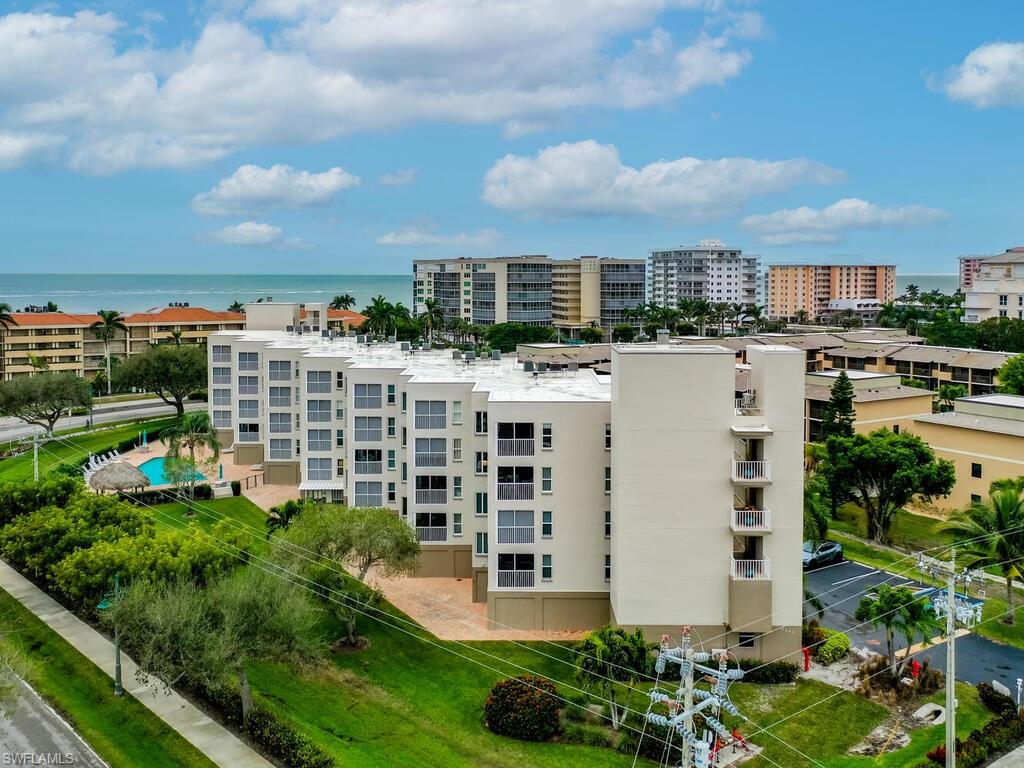 Birds eye view of property with a water view
