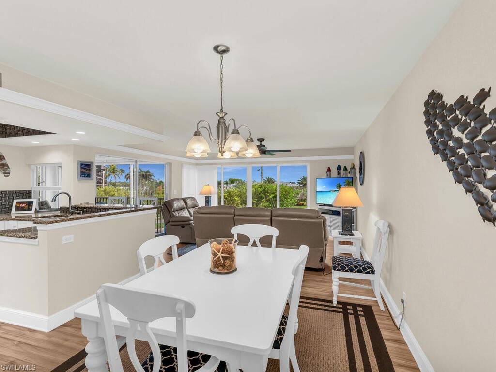 Dining space with a chandelier, light hardwood / wood-style flooring, and a wealth of natural light