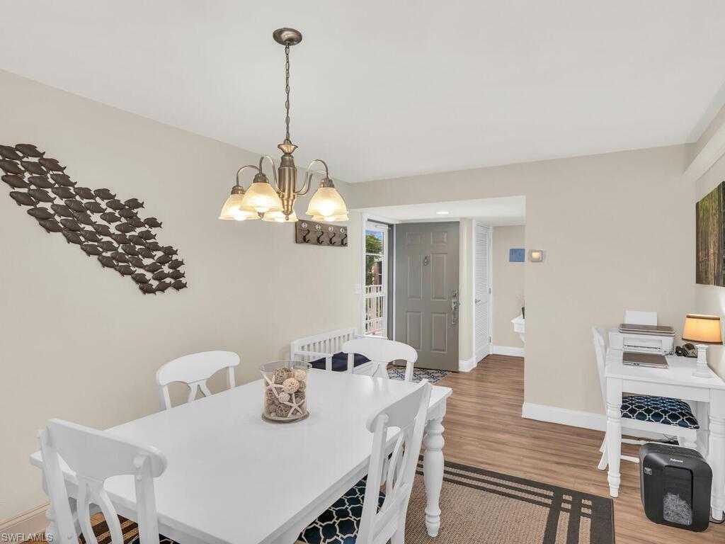 Dining room featuring hardwood / wood-style flooring and an inviting chandelier