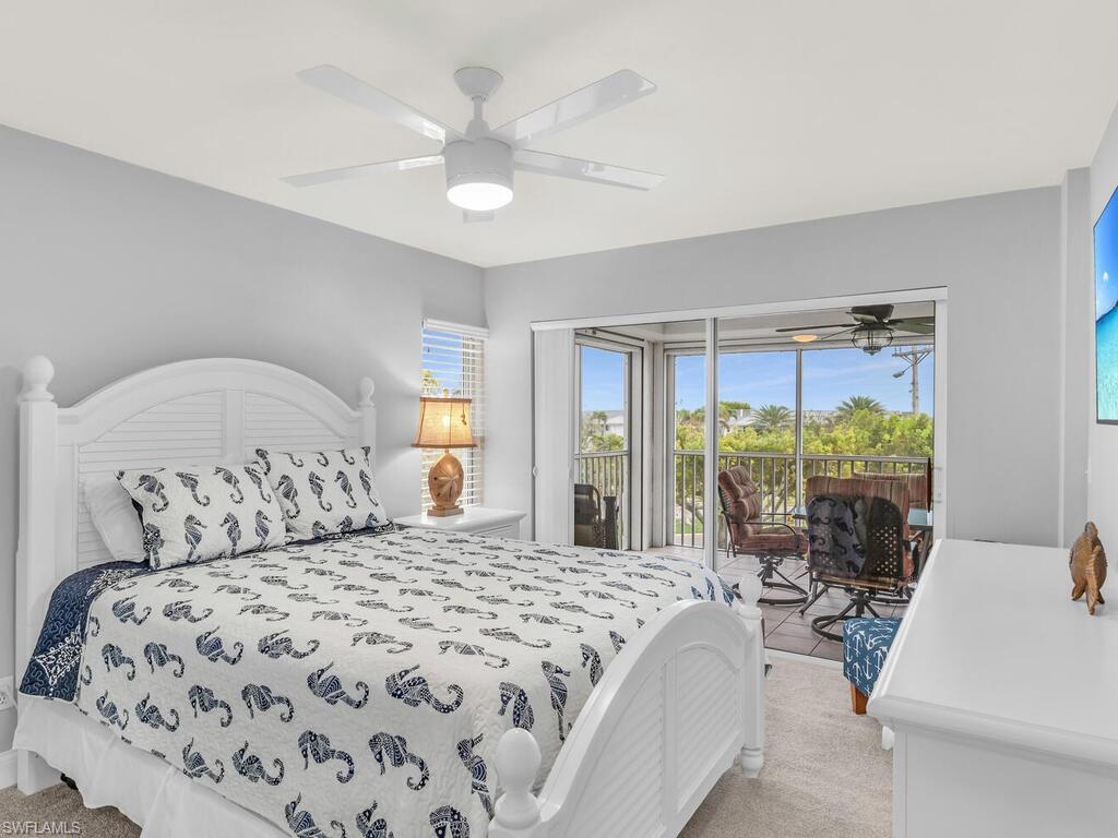 Bedroom featuring ceiling fan, access to exterior, and light carpet