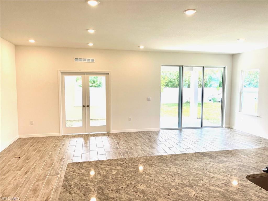 Open Great Room with plank ceramic tile flooring throughout.