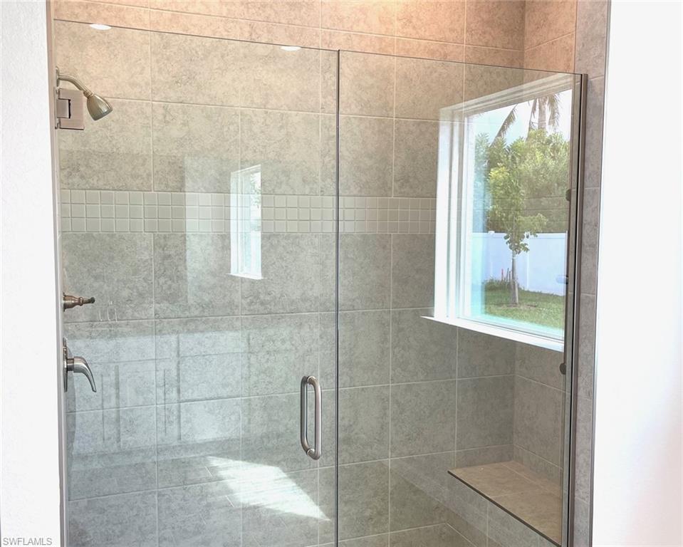 Primary Bath- Tile shower with enclosure & large picture window!