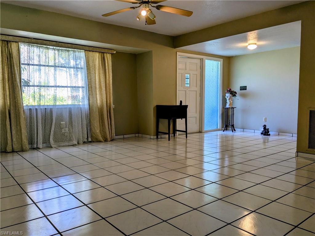Entryway featuring light tile patterned floors and a ceiling fan