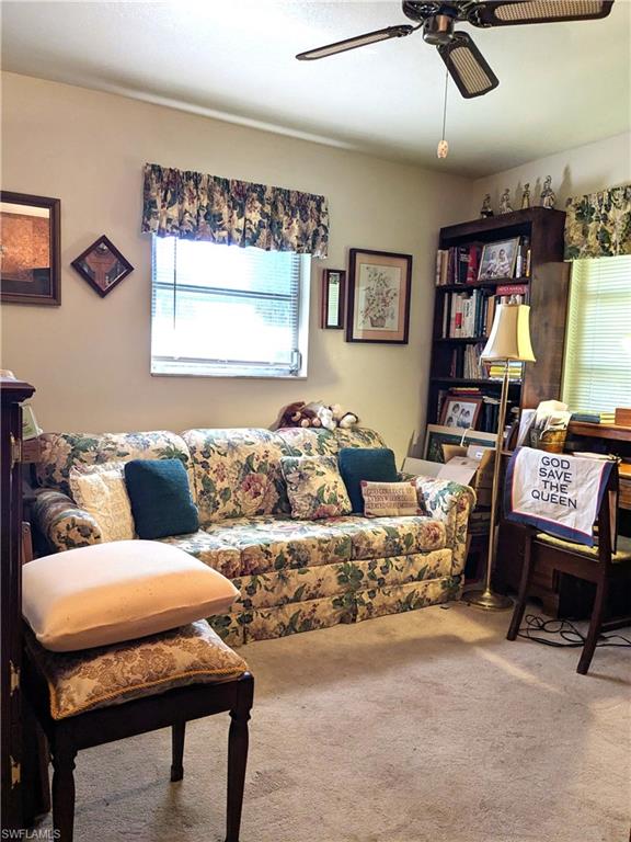 Carpeted room with ceiling fan