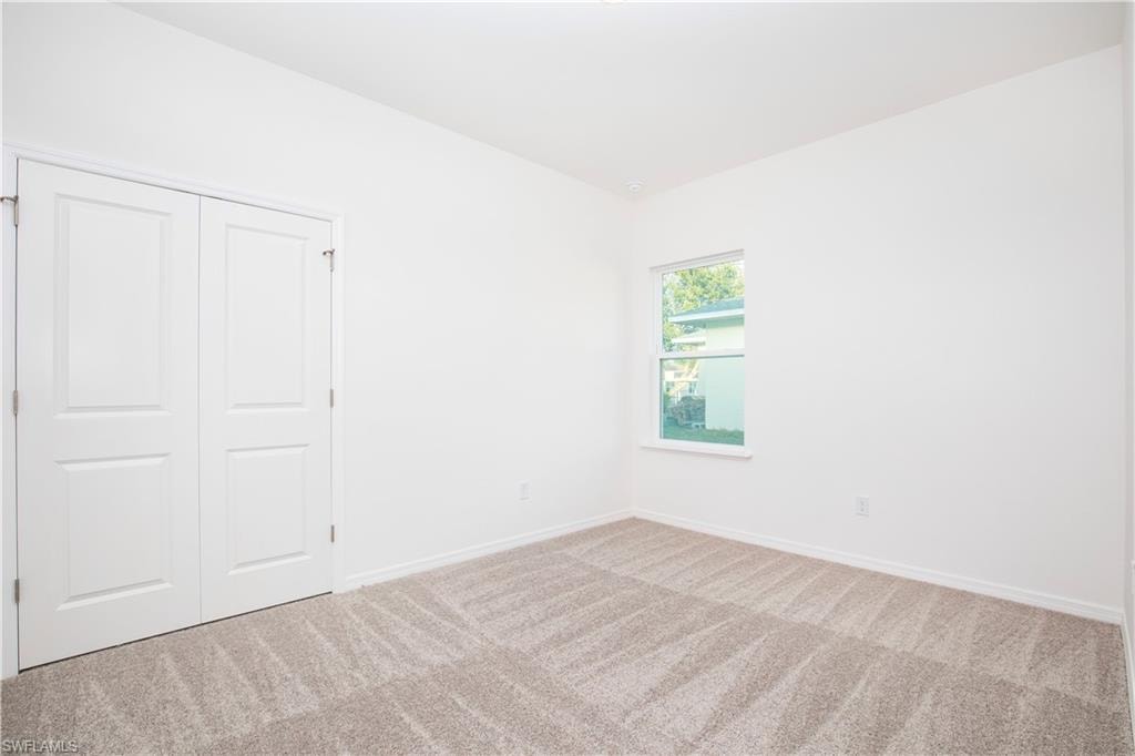 Unfurnished bedroom with carpet floors and a closet
