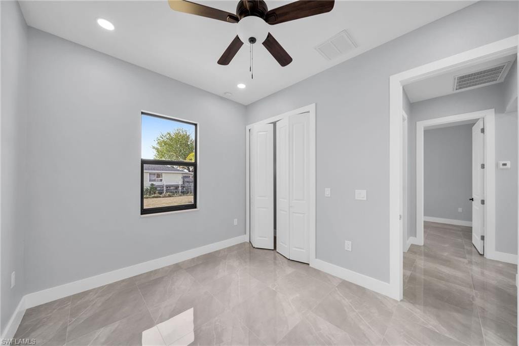 Unfurnished bedroom featuring ceiling fan and a closet