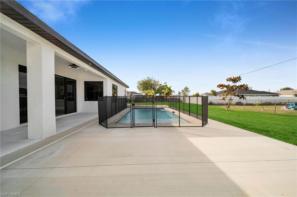 View of swimming pool featuring a yard and a patio