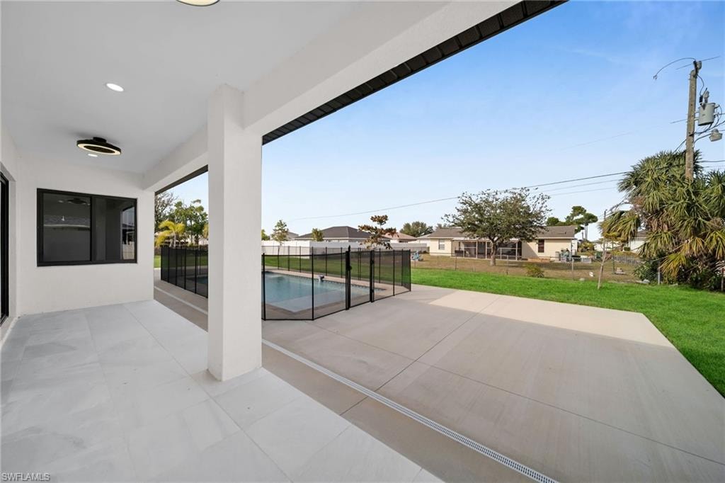 View of patio with a fenced in pool