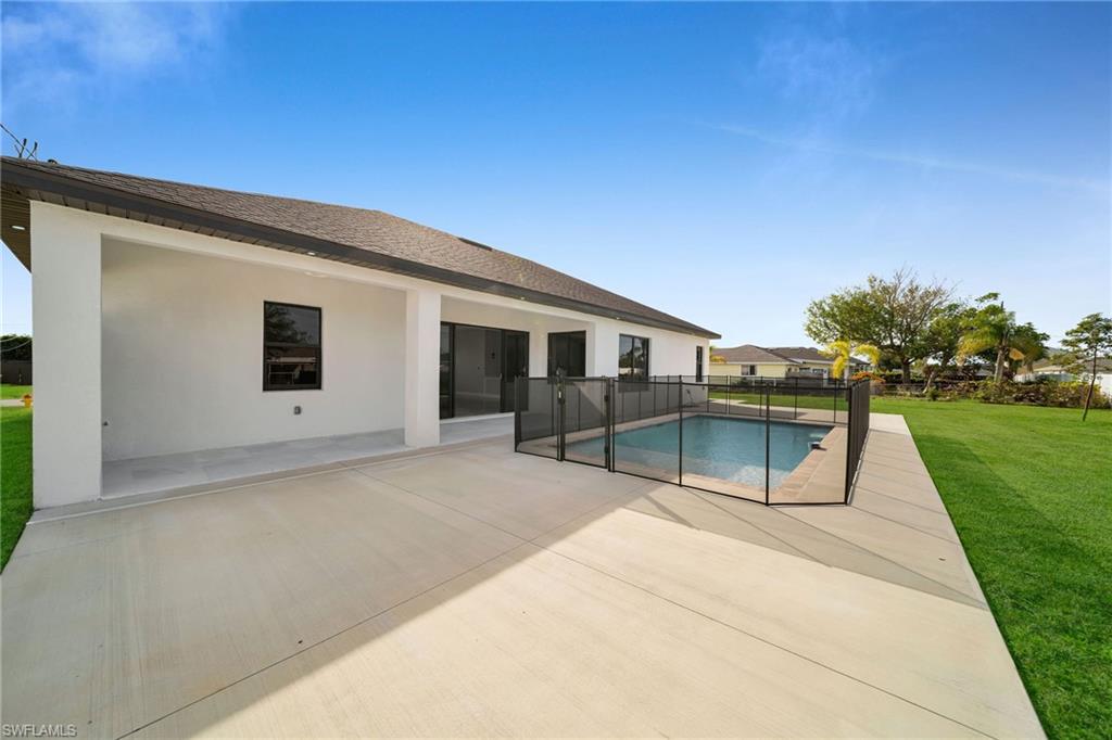 View of pool with a lawn and a patio
