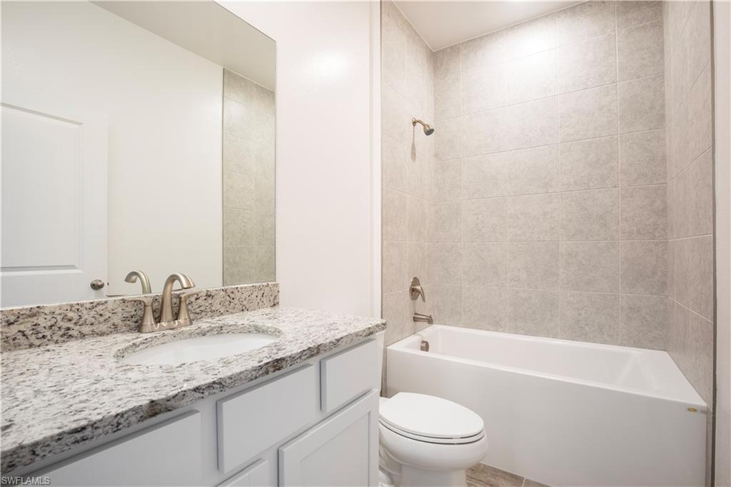 Bathroom featuring  shower combination and vanity