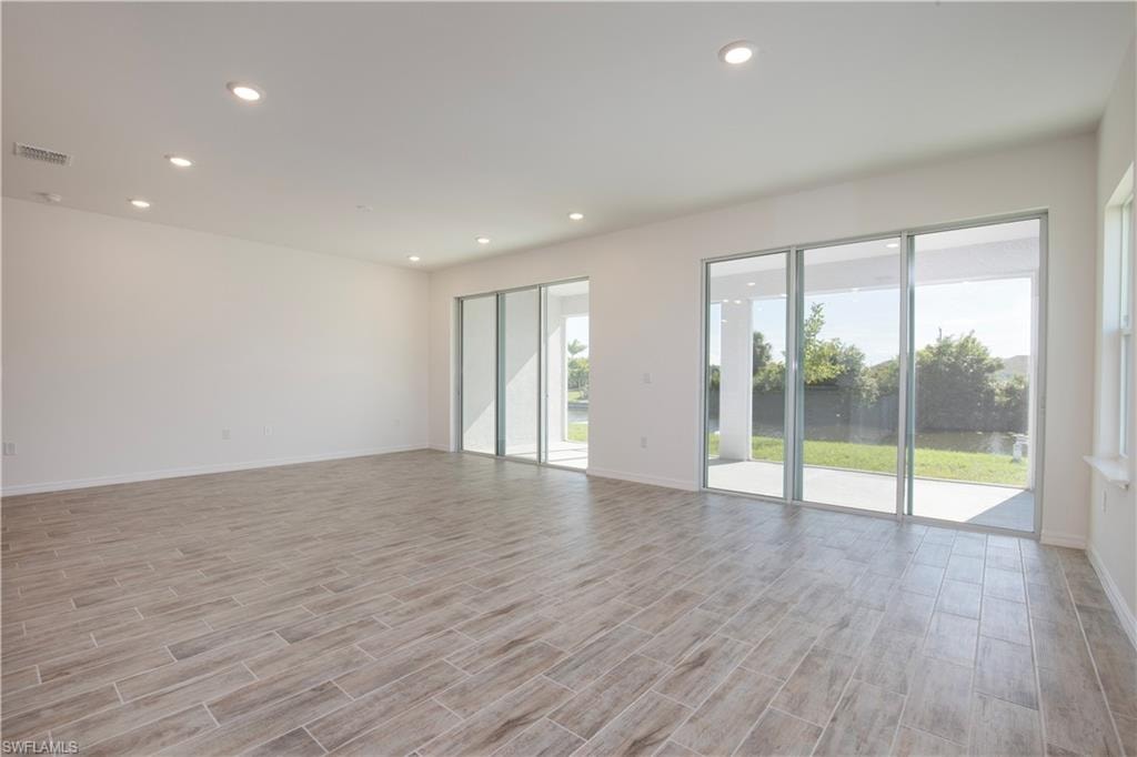 Empty room featuring wood tiled floors and recessed lighting