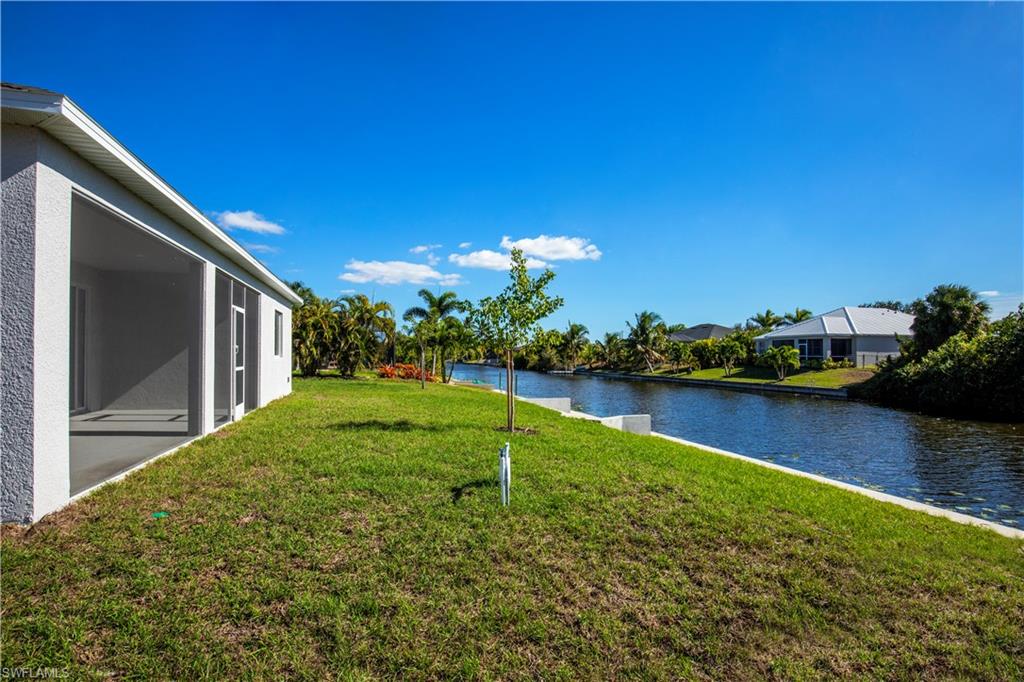View of green lawn featuring a water view