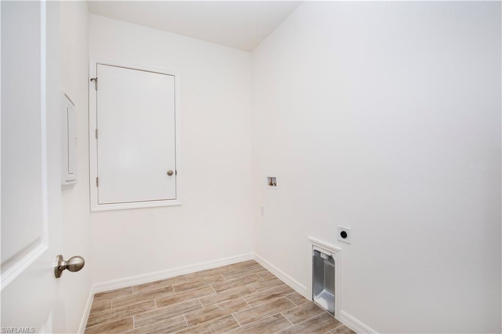 Laundry room featuring hookup for a washing machine, wood finish floors, and hookup for an electric dryer
