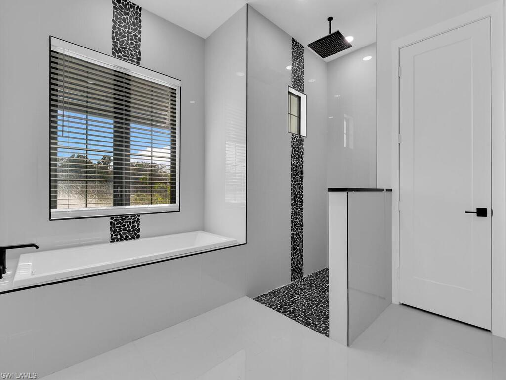 Bathroom featuring shower with separate bathtub