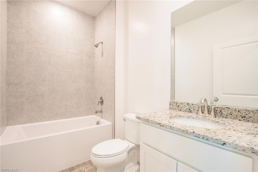 Bathroom with shower / bath combination and vanity