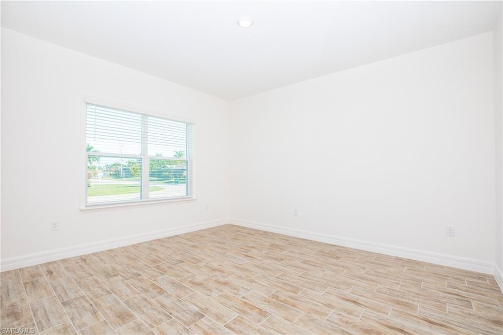 Spare room featuring wood finish floors