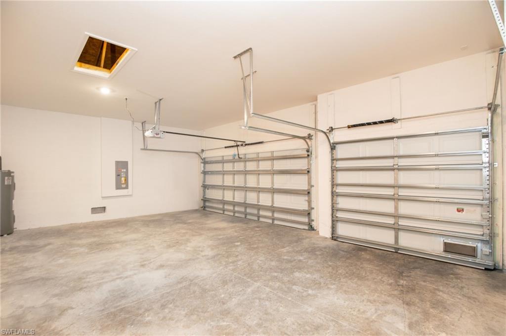 Garage with water heater and electric panel
