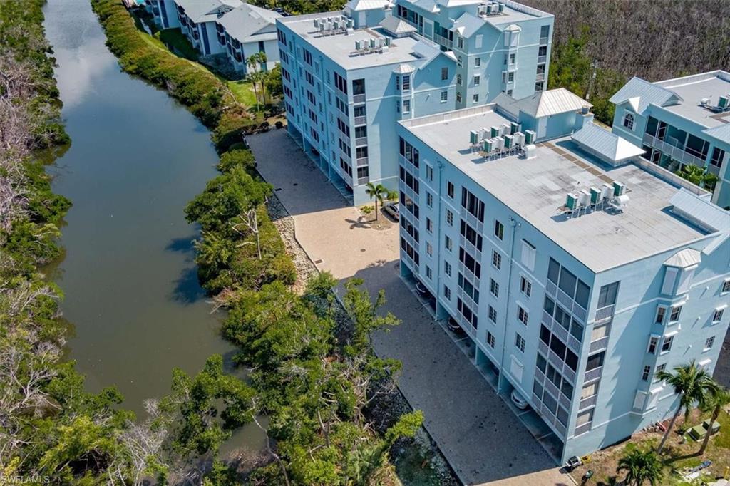 Birds eye view of property with a water view