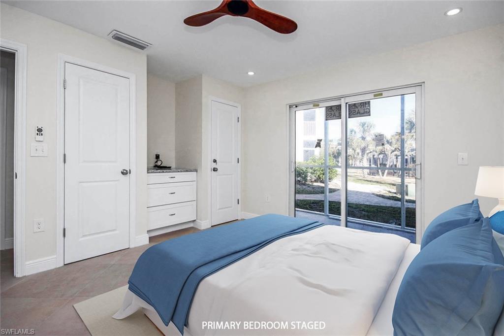Tiled bedroom with ceiling fan and access to outside