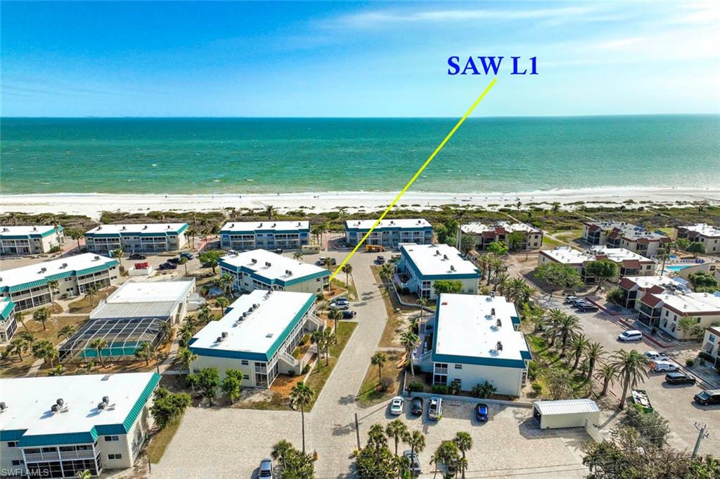 Aerial view with a water view and a beach view