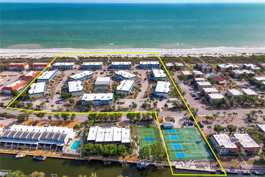Drone / aerial view with a view of the beach and a water view