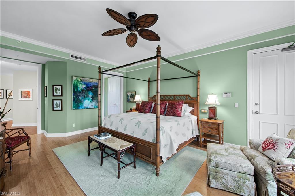 Bedroom with crown molding, light wood-type flooring, and ceiling fan