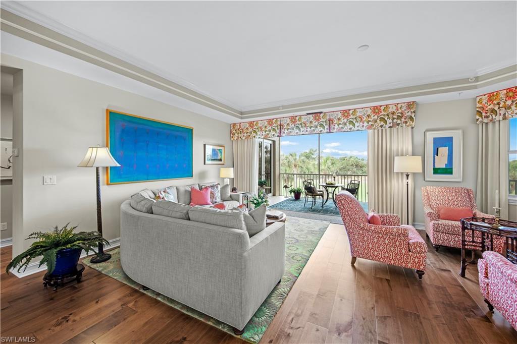 Living room featuring hardwood / wood-style floors and ornamental molding