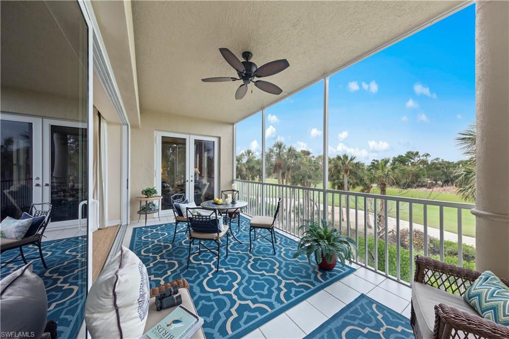 Sunroom / solarium featuring ceiling fan and french doors