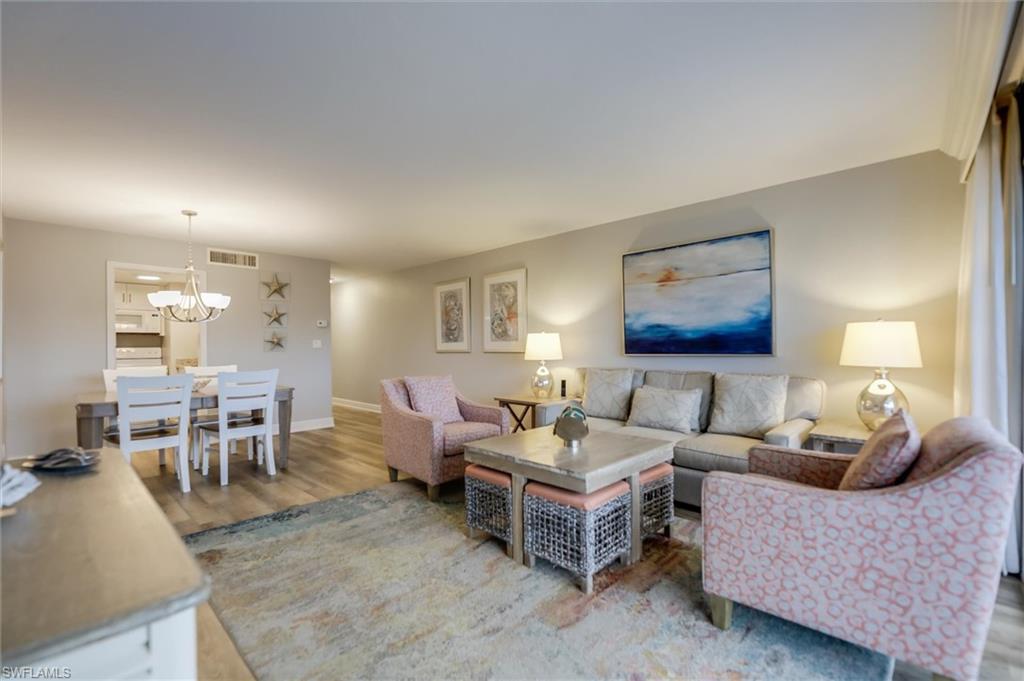 Living room with a chandelier and hardwood / wood-style floors
