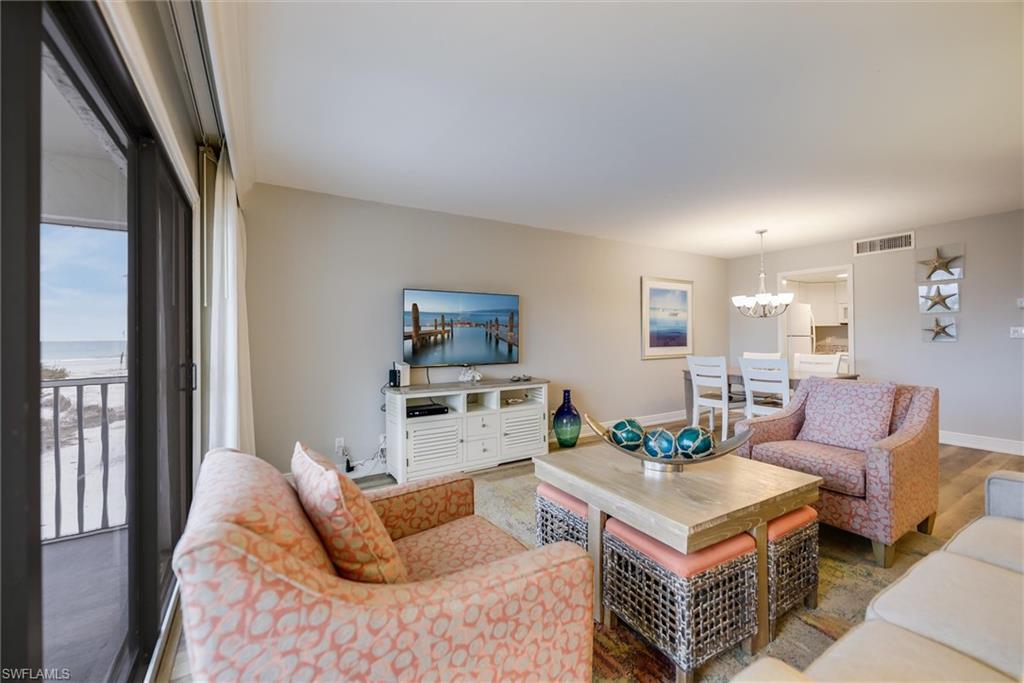 Living room featuring hardwood / wood-style flooring and a notable chandelier