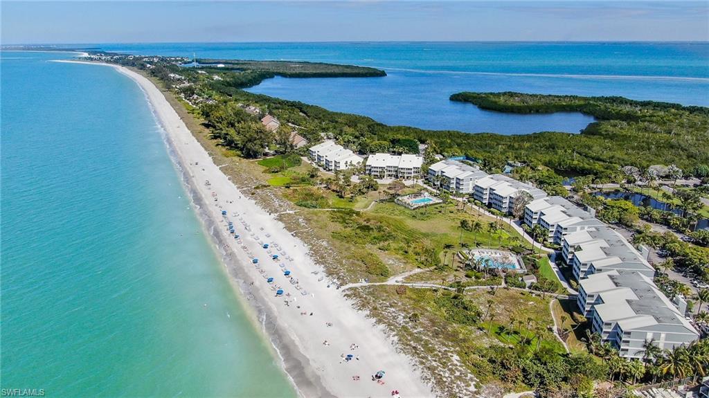 Aerial view with a water view and a beach view