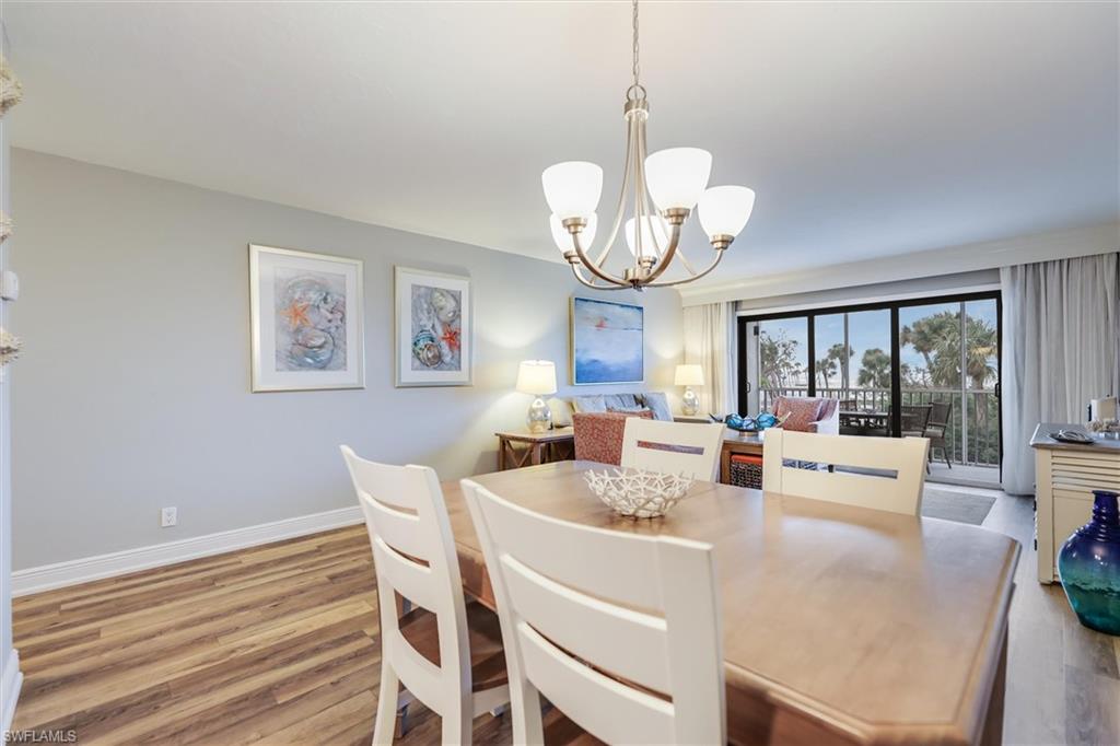 Dining room with an inviting chandelier and light hardwood / wood-style floors