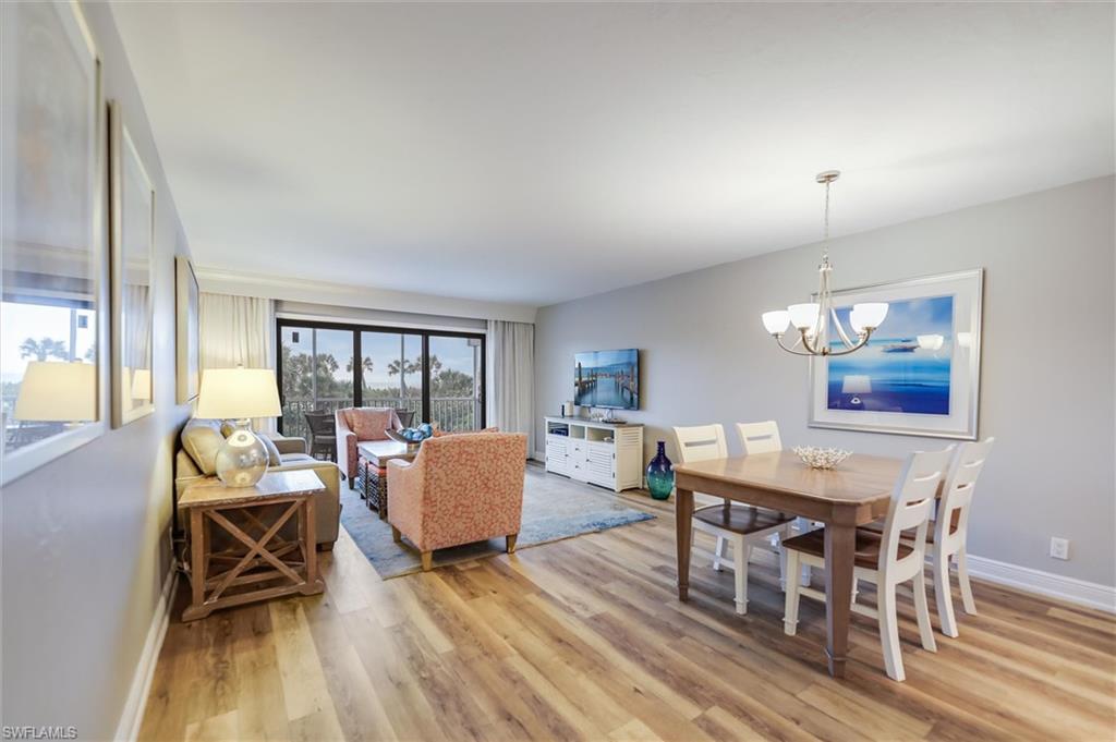 Dining room with an inviting chandelier and light hardwood / wood-style floors