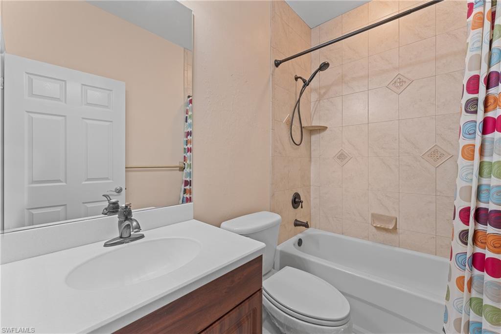 Full bathroom featuring toilet, vanity, and shower / tub combo