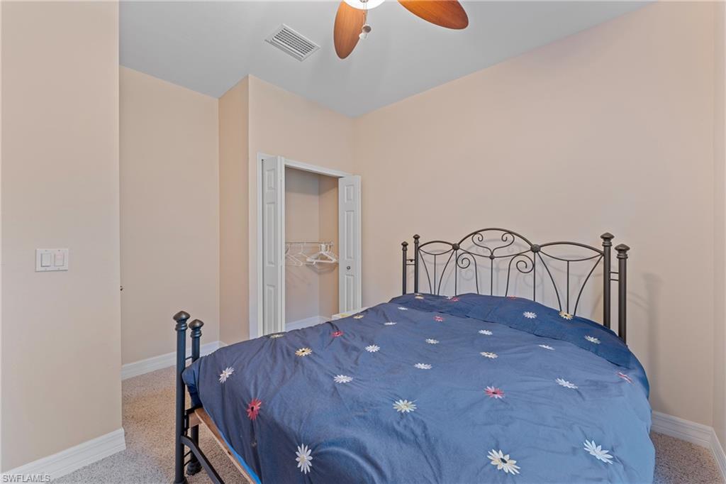 Bedroom with ceiling fan, carpet, and a closet
