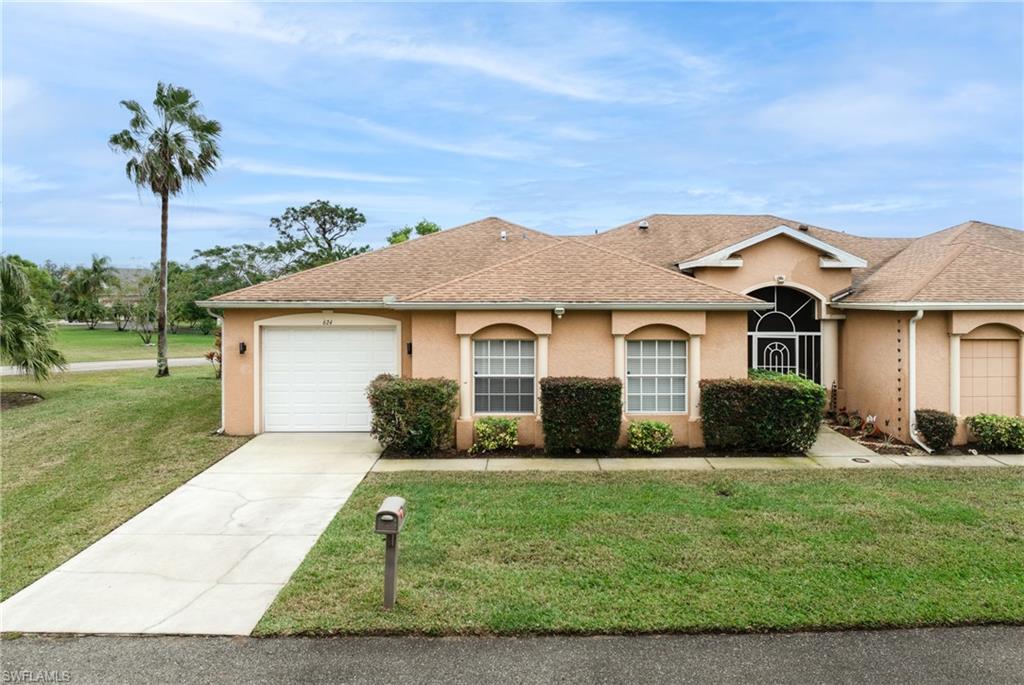 Ranch-style house with a front lawn and a garage