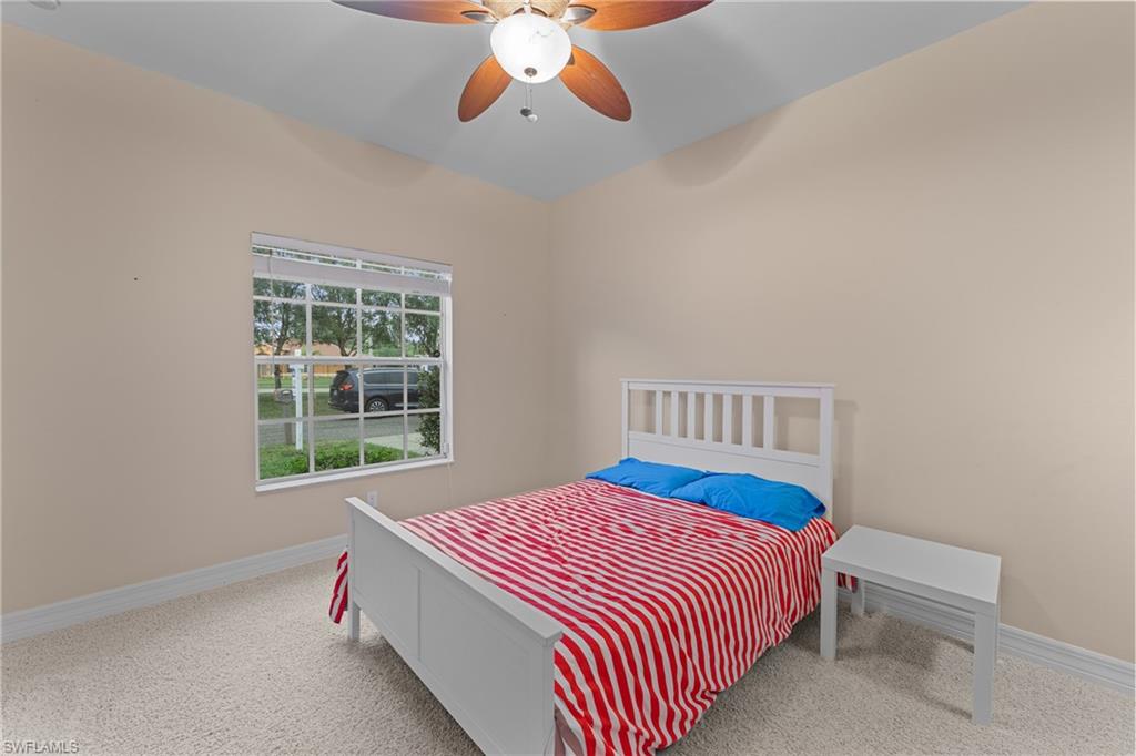 Carpeted bedroom with ceiling fan