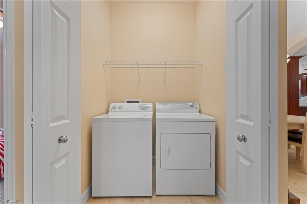 Laundry room featuring light tile patterned floors and washer and dryer