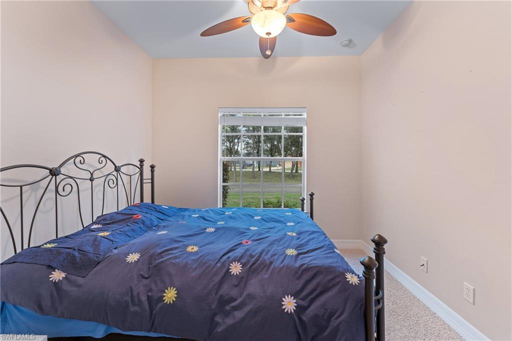 Bedroom featuring ceiling fan and carpet flooring